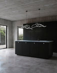 Modern kitchen with black island and concrete walls and floor