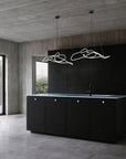 Modern kitchen with black island and concrete walls and floor