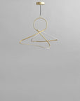 Brass chandelier on a gray background from 101 Copenhagen available at Spacio retail stores in Mumbai & Kolkata.