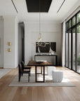 Modern dining room with wooden table, chairs, and a television in a well-lit room.