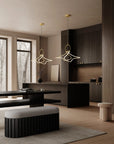 Modern interior with pendant lights, a bench, and a kitchen area.