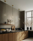 Modern Scandinavian theme kitchen with wooden cabinets, black countertops, and pendant lights.