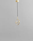 Brass pendant light on a gray background