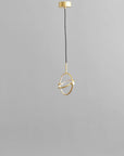 Brass pendant light on a gray background