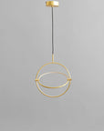 Brass pendant light fixture on a gray background