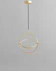 Brass pendant light fixture on a gray background