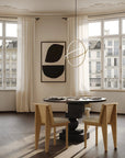 Modern Japandi theme dining room with round table and chairs, large windows, and abstract wall art.