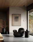 Modern Japandi theme interior with a black armchair, abstract painting, and large window.