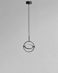 Modern pendant light with circular design on a gray background