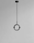 Modern pendant light with circular design on a gray background