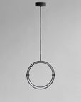 Modern pendant light with circular design on a gray background
