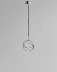 Modern pendant light with circular design on a gray background