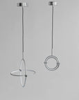 Two modern pendant lights with circular designs on a gray background