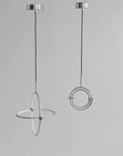 Two modern pendant lights with circular designs on a gray background