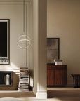 Modern interior design with a lamp, books, and framed pictures on a wall.