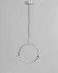 Modern pendant light with circular design on a gray background