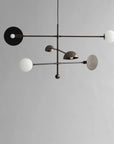 Modern Scandinavian minimal chandeliers with white spherical bulbs on a gray background from 101 Copenhagen available at Spacio retail stores in Mumbai & Kolkata.