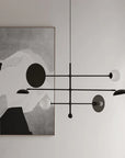 Modern chandelier with abstract art in the background