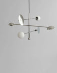 Modern chandelier with white spherical lights on a gray background from 101 Copenhagen available at Spacio retail stores in Mumbai & Kolkata.