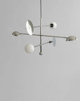 Modern chandelier with white spherical lights on a gray background from 101 Copenhagen available at Spacio retail stores in Mumbai & Kolkata.
