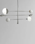 Modern chandelier with white spherical lights on a gray background