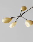 Modern chandelier with gold lampshades on a gray background