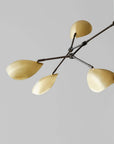 Modern chandelier with gold lampshades on a gray background