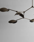 Modern chandelier with multiple lampshades on a plain background