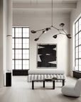 Modern living room with white walls, large windows, and minimal furniture.
