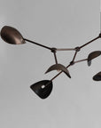 Modern chandelier with black and bronze design on a gray background