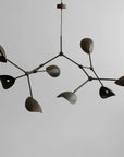 Modern chandelier with leaf-like design on a plain background from 101 Copenhagen available at Spacio retail stores in Mumbia & Kolkata.