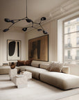 Modern living room with a sectional sofa, abstract art, and large windows.