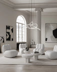 Modern living room with white furniture and abstract art