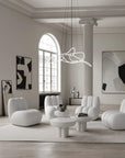 Modern living room with white furniture and abstract art