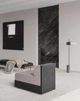 Modern interior with a gray sofa, black marble wall, and abstract art.