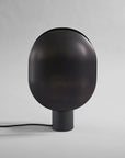 Black minimal design Japandi theme spherical lamp on a gray background from 101 Copenhagen available at Spacio retail stores in Mumbai & Kolkata.