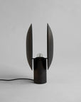 Modern black table lamp with unique design on a gray background
