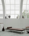 Modern lounge chair in a minimalistic room with large windows