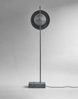 Modern floor lamp with circular design on a gray background