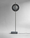 Modern floor lamp with circular design on a gray background