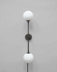 Wall-mounted lamp with two white spherical lights on a gray background
available at Spacio retail stores in Mumbai & Kolkata