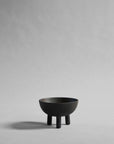 Coffee colour ceramic bowl on a gray background from 101 Copenhagen at Spacio retail stores in Mumbai & Kolkata.