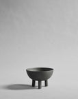 Dark Grey ceramic bowl on a gray background from 101 Copenhagen at Spacio retail stores in Mumbai & Kolkata.