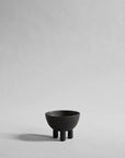 Coffee colour ceramic bowl on a gray background from 101 Copenhagen at Spacio retail stores in Mumbai & Kolkata.