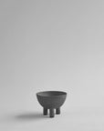 Dark grey ceramic bowl on a light gray background from 101 Copenhagen at Spacio retail stores in Mumbai & Kolkata.