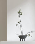 Minimalist arrangement of branches in a small bowl against a neutral background from 101 Copenhagen at Spacio retail stores in Mumbai & Kolkata.