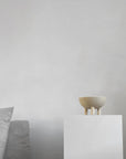 Small ceramic bowl on a white pedestal against a plain gray background from 101 Copenhagen at Spacio retail stores in Mumbai & Kolkata.