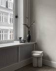 Modern living room and decorative elements from 101 Copenhagen in a corner beside the window