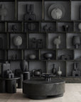 Collection of dark gray sculptures on shelves in a minimalistic room from 101 Copenhagen at Spacio retail stores in Mumbai & Kolkata.
