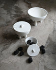 Set of white ceramic duck bowls and jars with blackberries on a stone surface from 101 Copenhagen at Spacio retail stores in Mumbai & Kolkata.